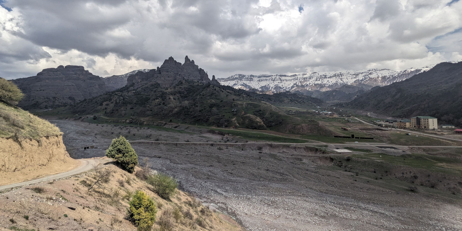 Northern exit road from the Childukhtaron geological formation crossing a wide rocky river bed