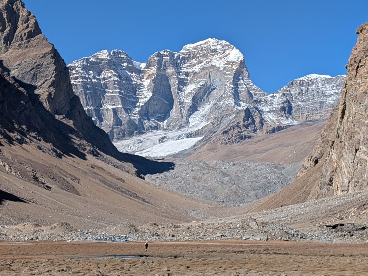 Hiker walking across meadows towards Engels Peak