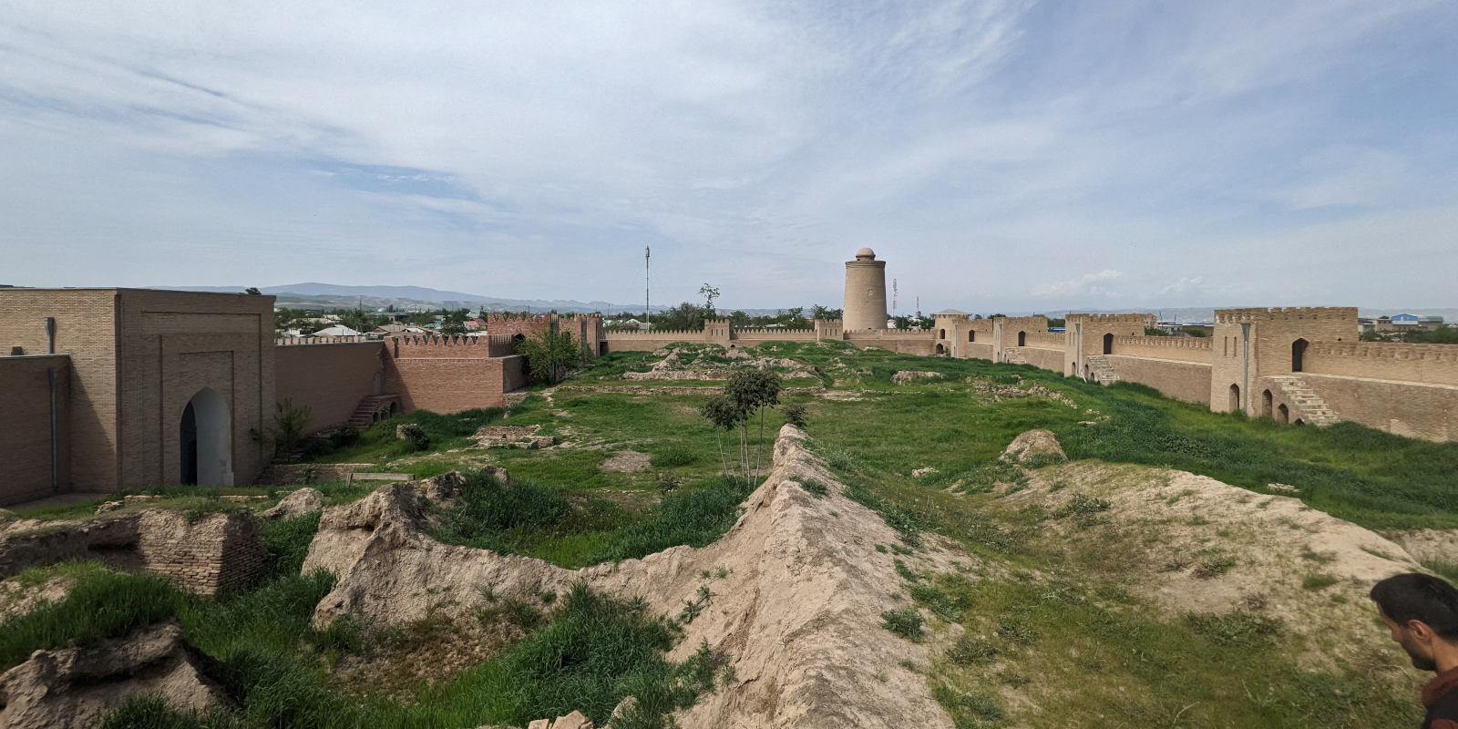 Overgrown palace court inside the fortified walls of the Hulbuk Fortress