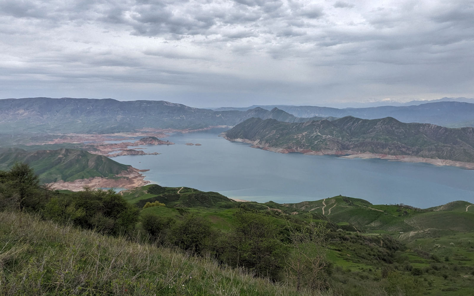 Wide view over the Norak Reservoir from a crest on its south shore with the Hisar Range visible