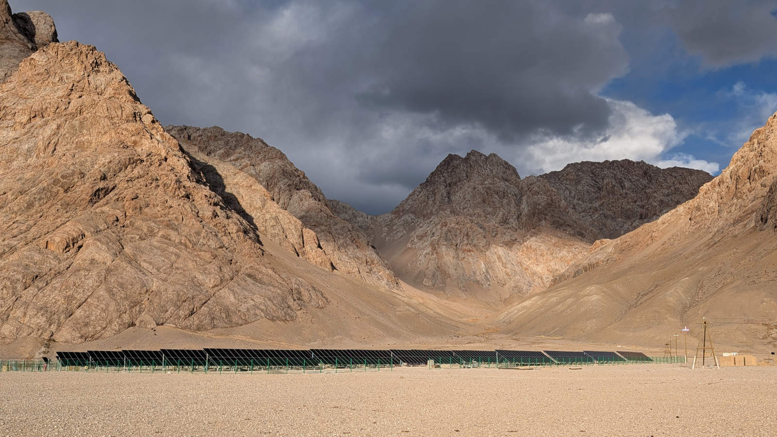 Solar power station in front of rugged mountains near the village of Shaimok