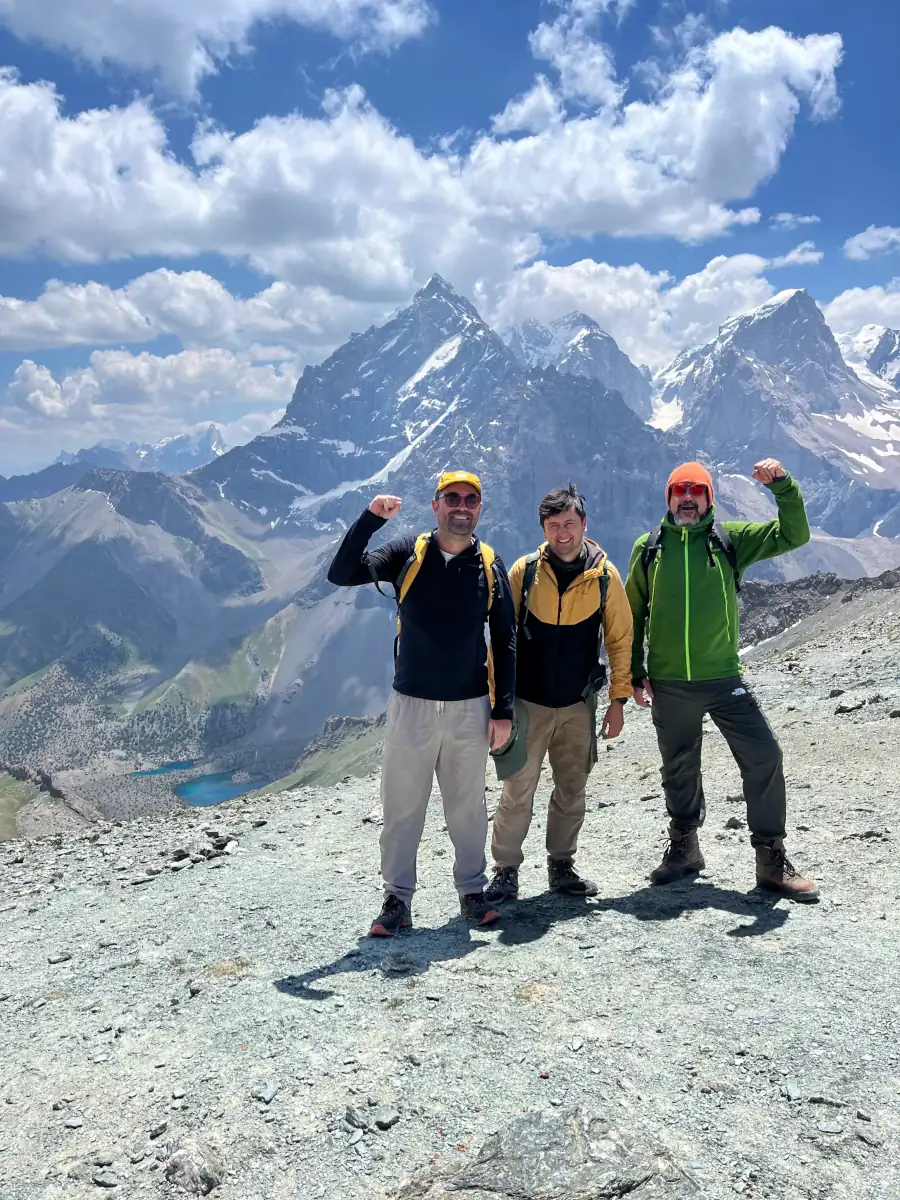Group picture of two hikers and a mountain guide